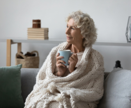 Older woman comfortably recovering on her couch