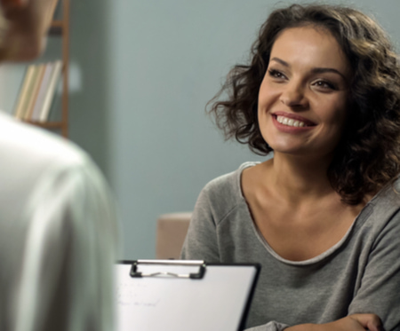 Woman confidently speaking with her doctor pre-surgery